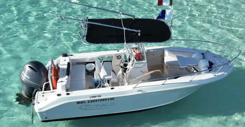 A premium private boat moored over turquoise water on a private Cozumel snorkeling tour of Palancar and El Cielo reefs